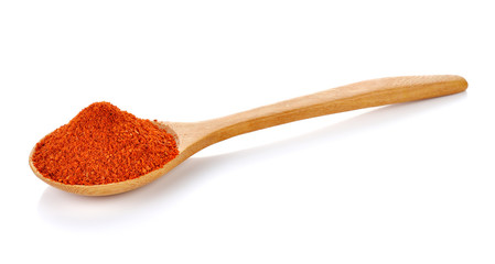 paprika on wooden spoon isolated on white