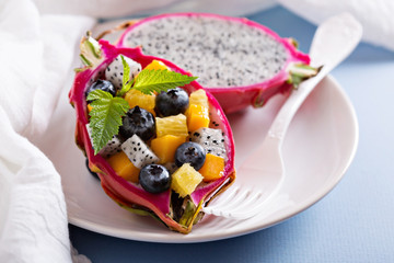 Tropical exotic salad inside a dragon fruit