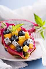 Tropical exotic salad inside a dragon fruit