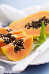 Cut papaya on a blue table