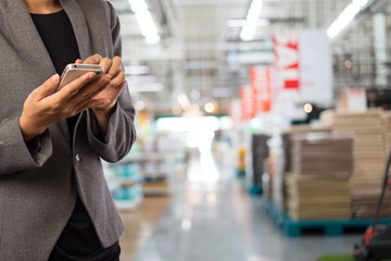 Women in shopping mall using mobile phone.