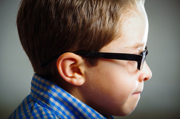 closeup portrait of cute boy wearing glasses