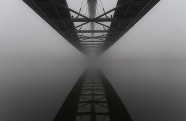 Fototapeta Bernatka footbridge over Vistula river in Krakow in heavy fog. obraz