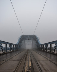 Pilsudski steel bridge over the Vistula river in Krakow in the morning fog