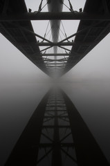 Bernatka footbridge over Vistula river in Krakow in heavy fog.
