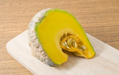 Raw Pumpkin on A Wooden Cutting Board