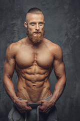 Fototapeta na wymiar Muscular man with beard showing his great body.