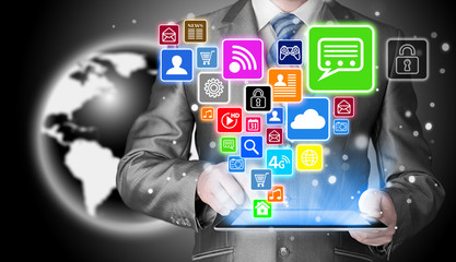 Business man using tablet PC with social media icon set