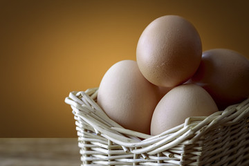 eggs in basket over wood