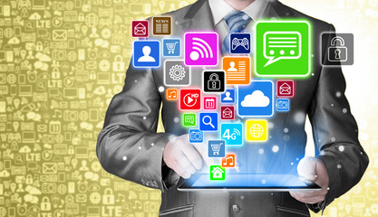 Obraz premium Business man using tablet PC with social media icon set