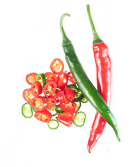 Sliced in pieces red and green chili peppers isolated over white