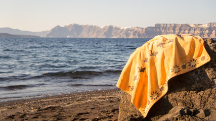 A lonely towel found in a Santorini's beach