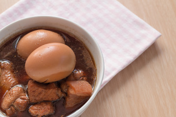 Thai Cuisine , Boiled eggs with chicken drumstick in sweet gravy.Eggs and pork in brown sauce.