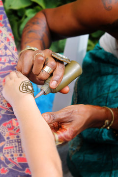 Process of applying Mehndi on girl hand close up