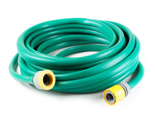 Rolled garden hose isolated on white