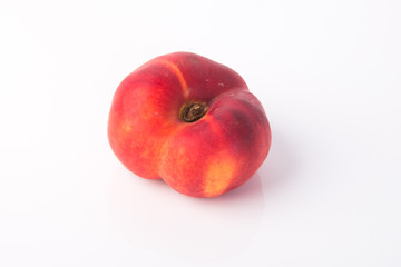 flat peaches (donut peaches) on a background
