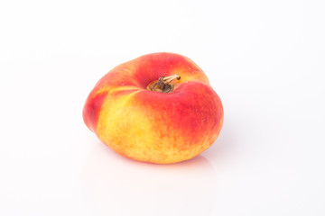 flat peaches (donut peaches) on a background