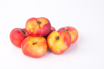 Fototapeta na wymiar flat peaches (donut peaches) on a background