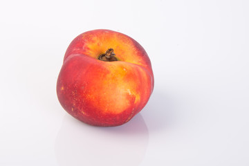 flat peaches (donut peaches) on a background