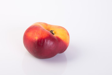 flat peaches (donut peaches) on a background