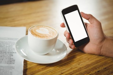 Fototapeta na wymiar High angle close-up of coffee and smartphone 