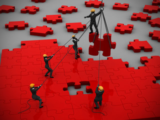 Red Jigsaw puzzle being built by teamwork. A great red jigsaw puzzle being built by a successful team.