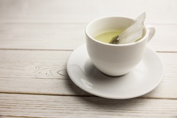 Cup of herbal tea on table
