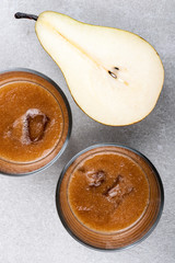 Two glasses of pear juices and ripe pear