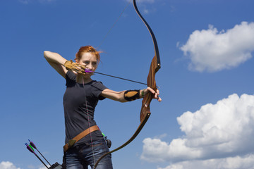 Archery woman bends bow archer target narrow