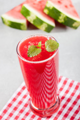 Glass of watermelon juice with ice and watermelon