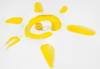 Vitamin D capsule in circle of sun painted on paper