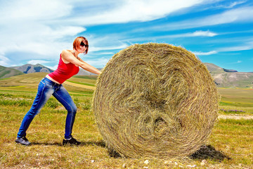 Naklejka na ściany i meble Girl and hay bale