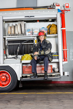 Happy Fireman Holding Coffee Mug In Truck