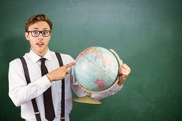 Composite image of geeky businessman pointing to globe