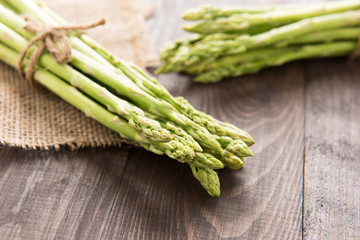 Bunch of fresh green asparagus on a rustic wooden table