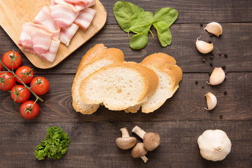 Ingredients for sandwich on wooden background