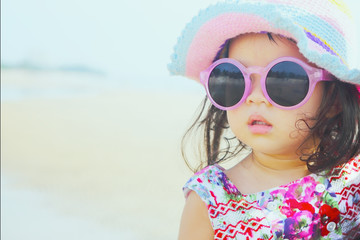 Beautiful Asian Baby Girl on Beach, Post-Processing with Retro Filter.
