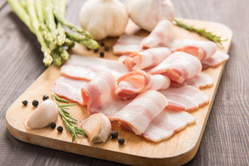 Smoked bacon slices on a wooden table