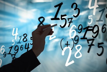 Composite image of hand holding a chalk and writing something