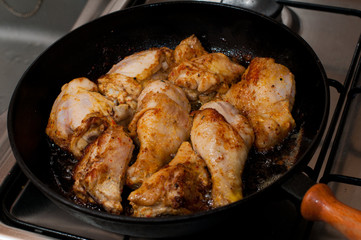 Frying pan with chicken legs inside