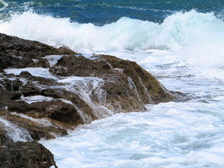 Big waves on rock coast blue sea and sky on Crete