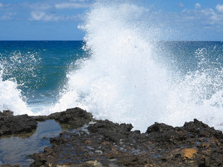 Big waves on rock coast blue sea and sky on Crete
