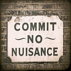 This old 'Commit no nuisance' street sign was photographed in the old docklands area near Tower Bridge in London. - 89348843
