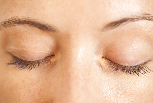 Closeup shot of woman closed eyes with makeup
