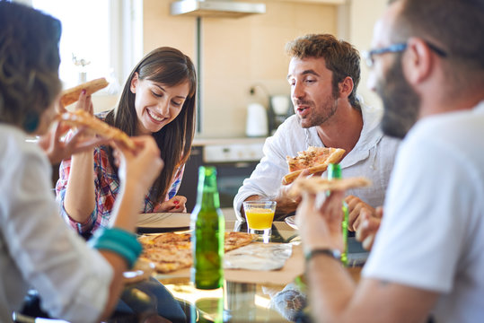 Two couples eating pizza