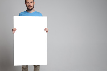 The man showing empty white billboard or banner 