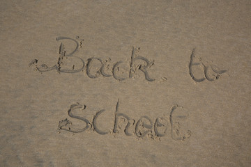 Back to school written in sand