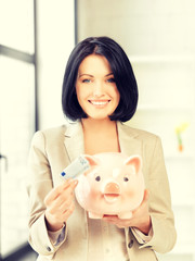 Obraz na płótnie Canvas lovely woman with piggy bank and money
