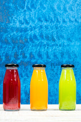 Juice bottle on vintage wooden background.