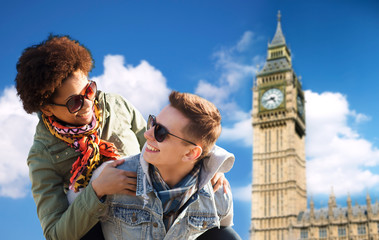happy teenage couple having fun over big ben tower